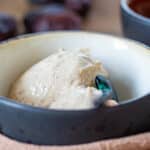 Proteinis med hytteost og dadler – cremet sundere dessert med højt proteinindhold serveret i en skål.
